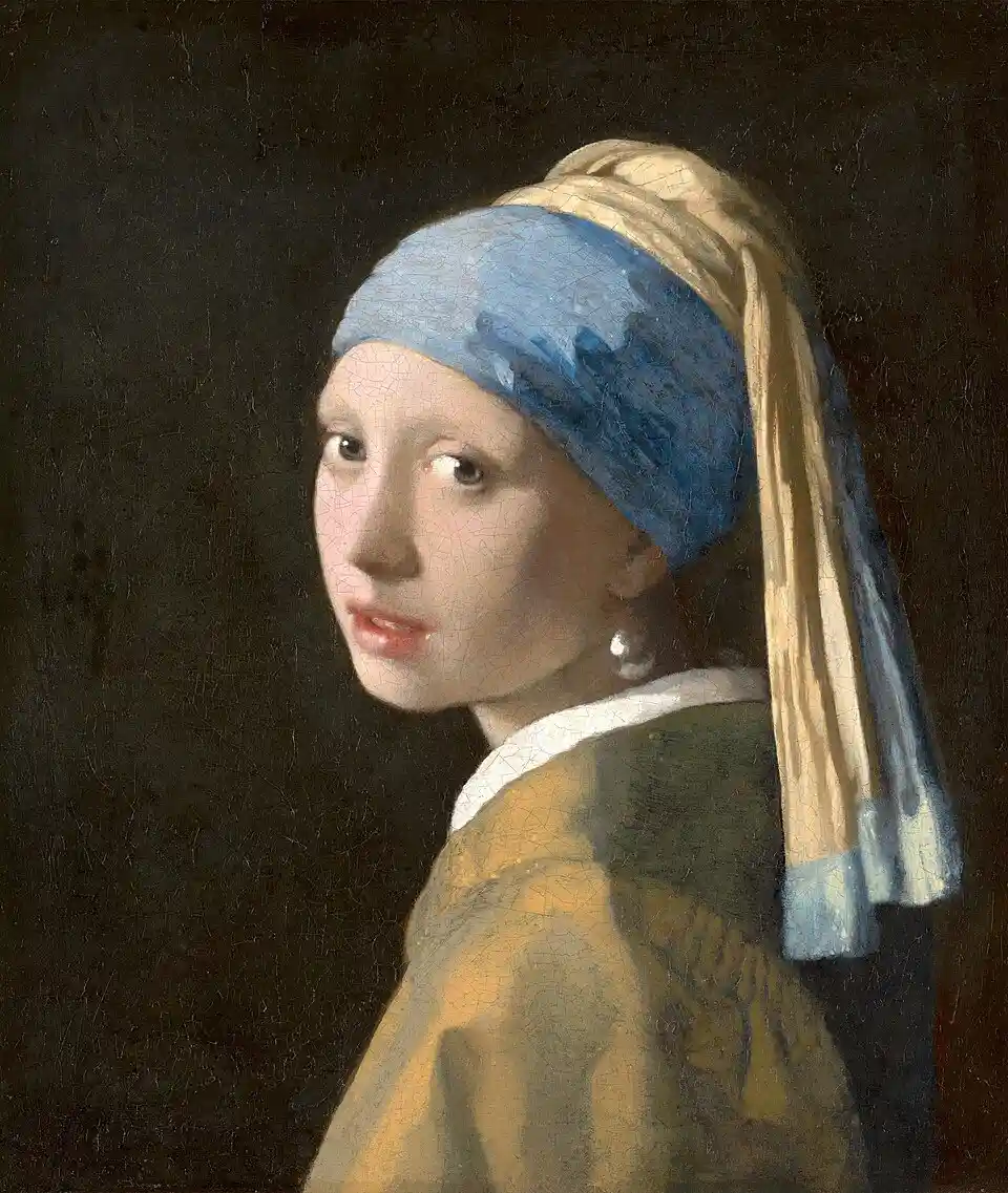 Johannes Vermeers maleri Piken med perleøredobb fra ca. 1665, som viser en ung pike i blå og gul turban som ser over skulderen mot betrakteren, med en stor perle i øret foran en mørk bakgrunn.